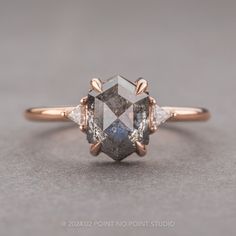 a diamond ring with three stone accents on it