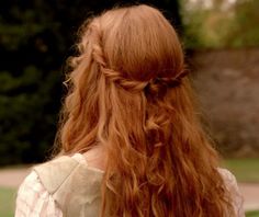 a woman with long red hair wearing a white dress