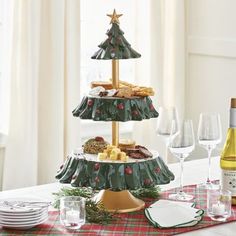 three tiered christmas tree platter with wine glasses and plates