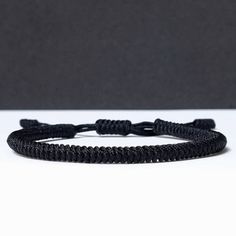 "◾ The handmade black Tibetan bracelet for luck and protection is a beautifully crafted accessory, each knot is meticulously tied whos creates an amazing pattern. ✅ Adjustable bracelet - the slip knot lets you adjust the size. ➰ Sizes: S - Fully Closed - 5.9\"inches (15cm) / Full Opened - 9.8\"inches (25cm) M - Fully Closed - 6.6\"inches (17cm) / Full Opened - 10.6\"inches (27cm) L - Fully Closed - 7.4\"inches (19cm) / Full Opened - 11.4\"inches (29cm) ⬛ The color of the bracelet is black. ◽ More colors and models are available in the shop. ◽ Just check out the shop. ✔️ Please note that due to the difference between different monitors, the image may not reflect the actual color of the item. ✍ If you have any questions please contact me." Black Woven Braided Bracelets As Gift, Black Braided Bracelets As Gift, Black Woven Braided Bracelets For Gift, Black Woven Braided Bracelet For Gifts, Adjustable Black Woven Friendship Bracelets, Black Woven Bracelet Gift, Adjustable Woven Bracelets For Everyday, Handmade Black Jewelry With Nylon Cord, Handmade Black Nylon Cord Jewelry