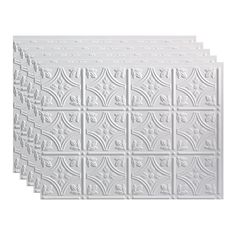 four white ceiling tiles with decorative designs on the sides and one is made out of plastic