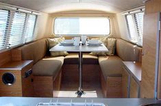 the inside of a camper with tables and benches