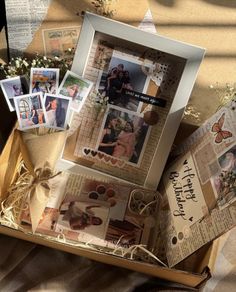 an open box filled with pictures and cards