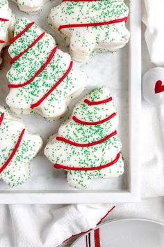 christmas sugar cookies decorated with white and green sprinkles in a square tray