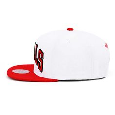 a white and red hat with the number 55 on it's side, sitting against a