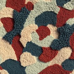 an abstract rug with red, white, and blue circles on it's surface