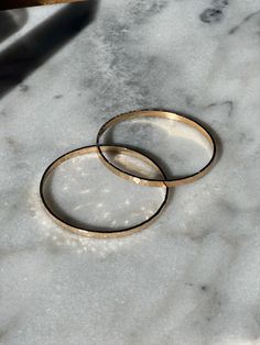 The Minerva bangle from Sun & Selene is crafted by hand in Richmond and features a distinctive hammered surface. Wear a single bangle to make a subtle statement, or style with multiple bangles for a bolder look. Its classic and versatile design pairs with both gold and silver jewelry, making it a perfect choice for day or night. Made in USA O/S Modern Hammered Bangle Bracelets, Modern Hammered Bangle For Everyday Wear, Modern Hammered Bangle For Everyday, Modern Hammered Bracelets For Everyday, Minimalist Hammered Bangle For Everyday, Minimalist Hammered Cuff Bangle Bracelet, Everyday Hammered Bangle Bracelets, Everyday Hammered Bangle Bracelet, Minimalist Hammered Cuff Bracelet