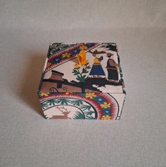 a small box with an image of people and animals on it