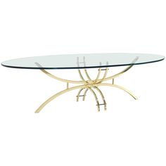 an oval glass table with gold metal legs