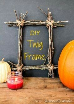 a frame made out of branches and some pumpkins next to it with the words diy two frame written on it