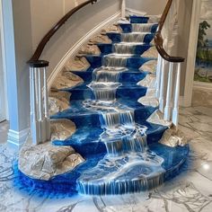 the stairs are painted with blue and white marble, while water is flowing down them