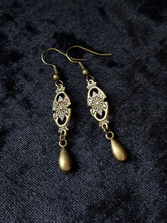 "These earrings are small and lightweight but very elegant and ladylike. If you want to add a little Victorian flair to your image without much commitment, this pair is a good find. MEASUREMENTS: The earrings are 5/16\" (0.8 cm) wide. Total length will depend on the earwires of your choice. With hooks - 2 1/16\" (5.2 cm) long; Lever backs - 1 15/16\" (4.9 cm) long; Studs and clip-ons - 1 11/16\" (4.3 cm) long Available with your choice of ear wires (select at checkout). See all the options in th Victorian Style Earrings, Romantic Earrings, Filigree Earrings, Leverback Earrings, Red Earrings, Black Earrings, Amethyst Earrings, Style Earrings, Victorian Style