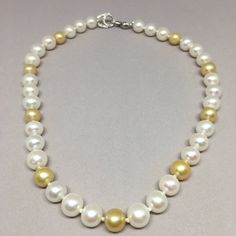 Genuine South Sea Pearl Necklace Genuine, luxurious South Sea Pearl Necklace. This necklace is all hand strung, and has a large, handcrafted 18K white gold and diamond lobster clasp. PEARL SIZE: WHITE PEARLS: 10 mm GOLDEN PEARLS: 9 mm PEARL SHAPE: Round PEARL COLOR: White and Gold. 30 White, 9 Golden on necklace. NECKLACE LENGTH: 17.5 inch CLASP: 18K White Gold Lobster Clasp DIAMONDS: Round Brilliant Cut Diamonds COLOR: G/H CLARITY: VS1 TOTAL WEIGHT: 0.50 ct TOTAL WEIGHT: 57.4 g Shipping is free Double Strand Pearl Necklace, Dramatic Necklace, South Sea Pearl Necklace, Beautiful Pearl Necklace, Bridal Pearl Necklace, Hematite Necklace, Pearl Bridal, Sea Pearl, Necklace Necklace