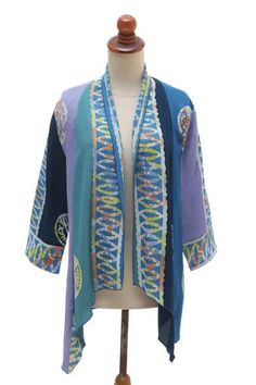 By Wayan Arta and Sharon in Bali this kimono jacket makes the perfect cover-up during the fall and spring seasons. Crafted from suave rayon this lightweight jacket is decorated using the batik method; a wax resist is stamped by hand onto the fabric before it is treated with colorful dyes resulting in cool hues of azure Pacific blue and violet decorated by circular pis bolong coin and spiral motifs. Multicolor Wrap Spring Outerwear, Multicolor Wrap Outerwear For Spring, Spring Multicolor Wrap Outerwear, Beach Outerwear With Kimono Sleeves In Multicolor, Blue Outerwear With Kimono Sleeves For Spring, Multicolor Batik Print Kimono For Spring, Spring Multicolor Kimono With Batik Print, Spring Vacation Batik Print Kimono, Spring Batik Print Long Sleeve Kimono