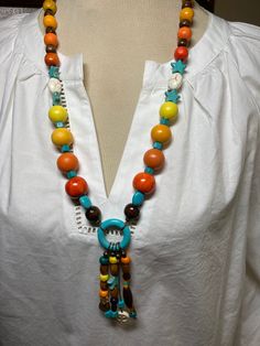 A single strand with pendant.  Another necklace that remind me of Aztec  culture.  A fun and multi colored necklace. Casual Turquoise Necklaces With Colorful Beads, Casual Turquoise Jewelry With Wooden Beads, Multicolor Lariat Long Necklace For Gifts, Large Beads Long Necklace For Beach, Handmade Multicolor Casual Necklaces, Multicolor Single Strand Necklace For Festival, Adjustable Multicolor Round Pendant Jewelry, Adjustable Multicolor Lariat Long Necklace, Colorful Handmade Casual Necklace