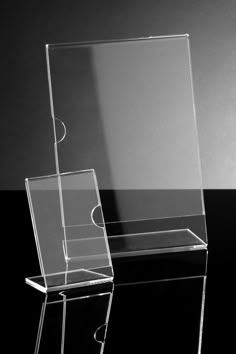 a clear acrylic display case on a black table with a moon in the background