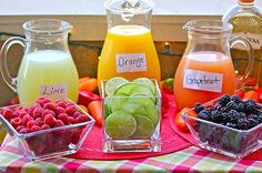 fruit and juices are displayed on a table