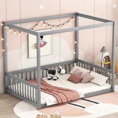 a small child's bed with pink and white decor on the wall behind it