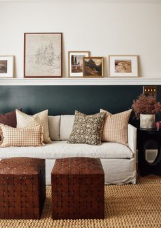 a living room filled with furniture and pictures on the wall