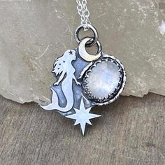 Handmade with sterling silver and brass (the moon) mermaid pendant with moonstone  The size is aprox 2.5cm high (plus jump rings) x 1.8cm width. Pendant deeply oxidized and polished. Chain length- 45cm *Metal: 100% Sterling silver (0.925) *Jewellery will be sent to you in a jewelry eco-box ♻️ *Free next day shipping via tracked delivery 📦  *All  jewelry is made by me in my small studio situated in Redhill, UK. If you have any questions please don't hesitate to contact me 🫶. Thank you for stopp Celestial Silver Labradorite Jewelry, Silver Labradorite Moon-shaped Jewelry, Silver Labradorite Jewelry With Moon Charm, Celestial Silver Labradorite Necklace, Silver Sterling Silver Mermaid Necklaces, Magical Moon Shaped Sterling Silver Necklace, Magical Moon-shaped Sterling Silver Necklace, Magical Silver Jewelry With Sun And Moon Design, Magical Sterling Silver Pendant Jewelry