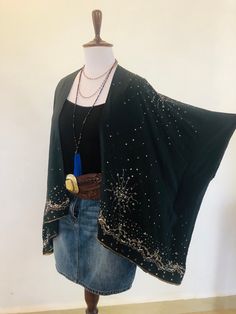 "A Unique and Truly Beautiful Kimono,Wrap Jacket. Silk and Sparkling with Sequins ; A Perfect Cover Up for Holidays and Parties. This has been Handmade from an Indian Sari.... so is completely Original and Sustainable. A Wonderfully Chic and Flattering Black Silk Crepe Fabric. The Gorgeous design features 1000's of Sparkling Silver and Irridescent Sequins,Beads and Diamante Crystals. This hip length Jacket drapes elegantly ,with loose Waterfall sleeves ,and is Floaty and Comfortable to wear. Sized to fit S M L XL UK  8 to 20 +  . US 4 to  16 +  European 36 to 50 +.  The length is 68 cm / 27 \" . The chest is 160 cm / 60 \" . This Beautiful unique jacket will soon become your Favourite Go To in your wardrobe . Timeless Boho Chic ! To see more unique designs like this please visit my Etsy Bo Black Fall Party Kimono, Bohemian Long Sleeve Cardigan For Party, Bohemian Long Sleeve Kimono For Evening, Bohemian Long Sleeve Evening Kimono, Black Embellished Cardigan For Party, Bohemian Fitted Cardigan For Party, Festive Beaded Outerwear, Bohemian V-neck Kimono For Party, Bohemian Sequined Festive Outerwear