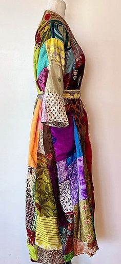 This stand-out kimono is full kaleidoscope of bright colors like a blooming spring garden. Constructed with high quality, ultra luxe sari silk, handmade. Designed as a traditional long kimono with an extra wide front band and self tie belt. Special detailing is noticable throughout the garment, double width hem panel, etc. Feels wonderful against your skin. Worn open, breezy flowing statement. The bright color pallet works well with most skin tones. True statement, one-of-a-kind designer piece. Multicolor Hippie Kimono With Kimono Sleeves, Hippie Multicolor Kimono With Kimono Sleeves, Long Multicolor Kimono For Festivals, Handmade Multicolor Kimono With Kimono Sleeves, Multicolor Handmade Kimono With Kimono Sleeves, Multicolor Bohemian Kimono For Festivals, Handmade Long Multicolor Kimono, Handmade Multicolor Spring Kimono, Traditional Multicolor Long Kimono