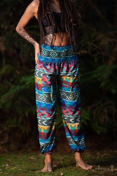 These tribal, bohemian-style pants are super soft and comfy! If your wish is freedom, your wish is these pants command! The Tribal Yoga Ali Baba Pants are light and breathable so they are ideal for yoga. They have elastic ends so they can be shortened for extra styling. In these pants, you can jump, twist, bounce, and be wild! CHECK THIS VIDEO OF A YOGA SESSION WITH THE PANTS : https://www.instagram.com/p/BPG46ZigA-P/ Material : 100% CottonMEASUREMENTS :Length:38.5 inches / 98cmWaist: 23.5 inche Casual Boho Print Pants For Festivals, Casual Boho Print Festival Pants, Stretch Harem Pants For Festivals, Multicolor Bohemian Pants With Boho Print, Multicolor Ankle-length Harem Pants With Elastic Waistband, Bohemian Festival Bottoms With Elastic Waistband, Stretch Hippie Pants For Festivals, Bohemian Yoga Pants For Summer Meditation, Hippie Style Long Yoga Pants For Meditation