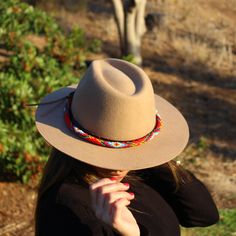 Price includes a Lola Sambboho hat & a Red Vogue hatband. Save 10% with this bundle. Select hat size. Hatband is one size fits all. Hatband is removable. An iconic must-have Fedora hat that will never get out of fashion. Sambboho's Lola hat has a soft brim and indented crown. A chic piece to be worn at all seasons of the year. The timelessness chic and sophistication exuded by this hat make it a lifetime wardrobe investment you’ll never regret! Classic Fedora design in Sand color Trimmed wit Red Vogue, Seasons Of The Year, Sand Color, Hat Band, Fedora Hat, Hat Making, Hat Sizes, All Seasons, One Size Fits All