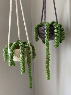 two crocheted plants hanging from hooks