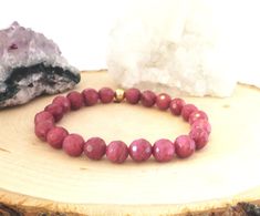 Rhodonite and 14k Gold Plated Stretch Bracelet Wear alone or stacked with other bracelets   Rhodonite  Faceted Grade AAA Genuine Natural Gemstone According to Experts  What is the meaning of Rodonite beads? Rhodonite is a stone of compassion, an emotional balancer that clears away emotional wounds and scars from the past, and that nurtures love. It stimulates, clears and activates the heart. Rhodonite grounds energy, balances yin-yang, and aids in achieving one's highest potential. It heals emot Valentine's Day Gift Bracelets With Faceted Beads, Valentine's Day Gift Bracelet With Faceted Beads, Pink Faceted Bracelets As Gift, Birthday Present For Friend, Mother Daughter Granddaughter, Present For Friend, Birthday Presents For Friends, Rose Bracelet, Dark Rose