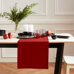 the table is set with black and red place settings