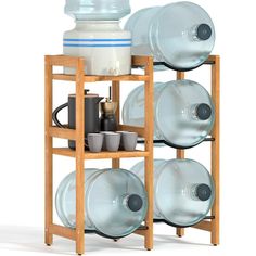 a wooden shelf with dishes and cups on it, next to a water bottle in the middle