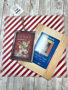 there are two framed pictures on top of a striped tablecloth with a red and white stripe