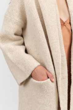 The Capote Coat is a stylish long cardigan featuring long sleeves, a relaxed hood, and a drop shoulder design, making it an ideal layering piece for the fall season. Made from softly felted Alpaca, it offers both comfort and warmth, ensuring you stay chic and cozy all season long. Felted Alpaca, Capote Coat, Christian Wijnants, Lauren Manoogian, Tassel Scarf, Skirt Jumpsuit, Knit Tees, Shoulder Design, Sweater And Shorts