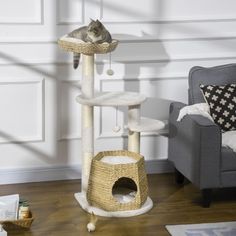 a cat sitting on top of a scratching post in a living room next to a chair