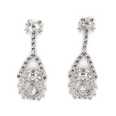 Handcrafted dangling platinum earrings with ribbon and floral motif. Accented with round diamonds 2.61 ct in total. Diamonds are all natural and white in G-H Color Clarity VS. Butterfly studs. Width: 1.5 cm Height: 4 cm Weight: 29.45 g Oval Diamond Earrings For Evening, Platinum Bridal Earrings With Diamond Accents For Evening, Evening Platinum Diamond Cut Earrings, Diamond White Platinum Bridal Earrings For Evening, Platinum Diamond Earrings With Diamond Accents For Evening, Elegant Chandelier Earrings With Rose Cut Diamonds, Vintage Platinum Earrings With Brilliant Cut, Evening Platinum Diamond Earrings With Single Cut Diamonds, Evening Platinum Earrings In Diamond White