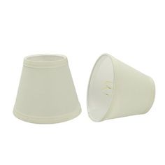 two white lampshades sitting next to each other