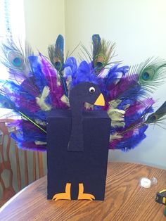 a paper bag with peacocks on it sitting on a table