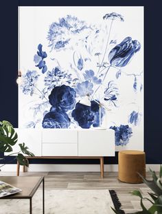 a blue and white floral wallpaper in a living room with an entertainment center next to it