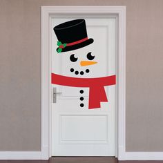 a door decorated with a snowman wearing a top hat and scarf, standing in front of a wall