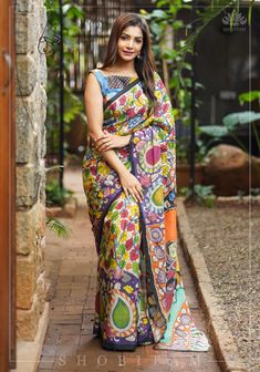 This light and comfortable Chennuri Silk is the perfect canvas for Large Kalamkari-Floral Motifs and Radha Krishna in the Pallu that are rendered completely by hand using the noteworthy kalamkari technique. This saree is ready to wear with fall and pico done.  An unstitched blouse fabric is included. Note: The blouse that the model is wearing is for styling purposes only. The actual blouse piece that comes with the saree is the same fabric as the saree. The blouse that the model is wearing can b Handmade Saree, Designer Blouses Online, House Of Blouse, Kalamkari Sarees, Hand Painted Sarees, Saree Blouse Patterns, Kalamkari Saree, Saree Designs Party Wear, Blouse Online