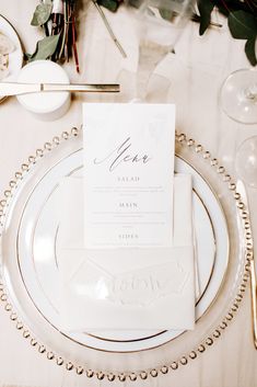 a place setting with white plates and silverware