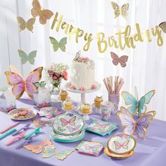 a table topped with plates and cake covered in butterflies