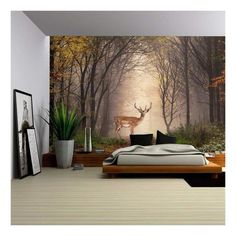 a bedroom with a deer in the woods wallpapered on it's walls