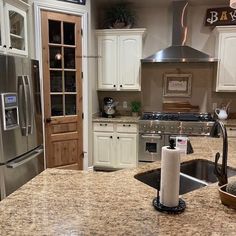 a kitchen with granite counter tops and stainless steel appliances in the middle of the room