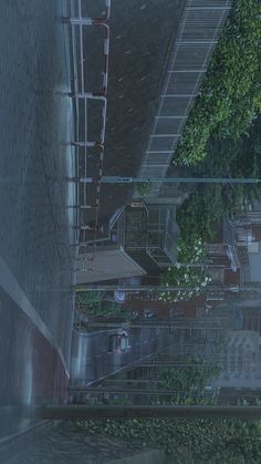 an aerial view of buildings and trees in the rain