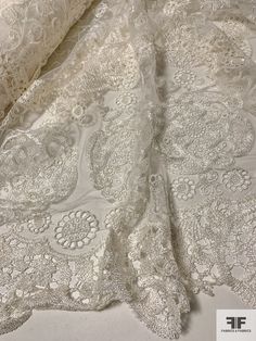 SKU: 10397 Content: Polyester Color: Ivory Width: 48 inches (embroidered area) White Embroidered Fabric With Lace Trim For Ceremonies, Cream Embroidered Lace For Ceremony, Elegant Cream Embroidered Lace Fabric, Elegant Cream Lace Embroidered Fabric, Elegant White Fabric With Chikankari Embroidery, Ceremony Embroidered Cream Lace, Elegant White Chikankari Embroidered Fabric, White Intricate Embroidered Lace For Ceremony, Elegant White Embroidered Fabric And Notions