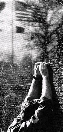 a man laying on top of a bed next to a window covered in words and trees