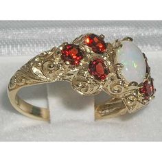 *This ring is made from 375 9K (9ct 9Kt) Yellow Gold with Genuine Natural Opal & Garnets.Like all my jewelry pieces, this ring is made in my own workshop. PLEASE MAKE SURE YOU STATE THE FINGER SIZE YOU REQUIRE WITH YOUR PAYMENT AND ALSO INCLUDE YOUR TELEPHONE NUMBER FOR DELIVERY COURRIER.A beautiful Opal & Garnet Ring set with a center 7x5mm (0.28"x0.20") colorful Opal & six 3mm (0.12" inches) beautiful Garnets in a stylish Victorian Style cluster setting in solid 9K Yellow Gold. Thi Luxury Yellow Gold Opal Ring With Accent Stones, Exquisite Yellow Gold Opal Ring For Anniversary, Exquisite Yellow Gold Opal Anniversary Ring, Luxury 14k Gold Round Opal Ring, Elegant 14k Gold White Ruby Ring, Exquisite Yellow Gold Opal Ring Gift, Elegant White Ruby Ring In 14k Gold, Luxury 14k Gold Opal Ring For Anniversary, Formal 14k Yellow Gold Opal Ring