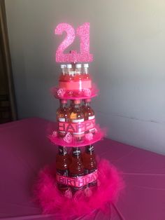 there is a cake made to look like a tower with beer bottles on the top